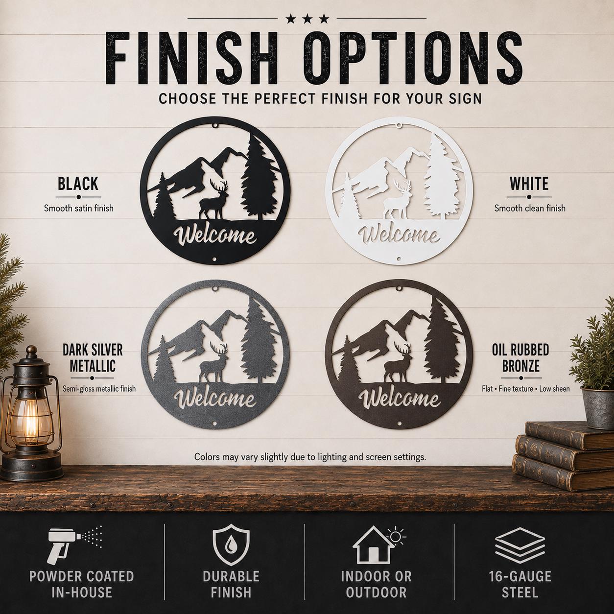 A finish options graphic for a round hanging sign with a mountain and deer silhouette and the word 'Welcome.' The image shows four finish choices: black, white, dark silver metallic, and oil rubbed bronze, with text labels and finish icons along the bottom.