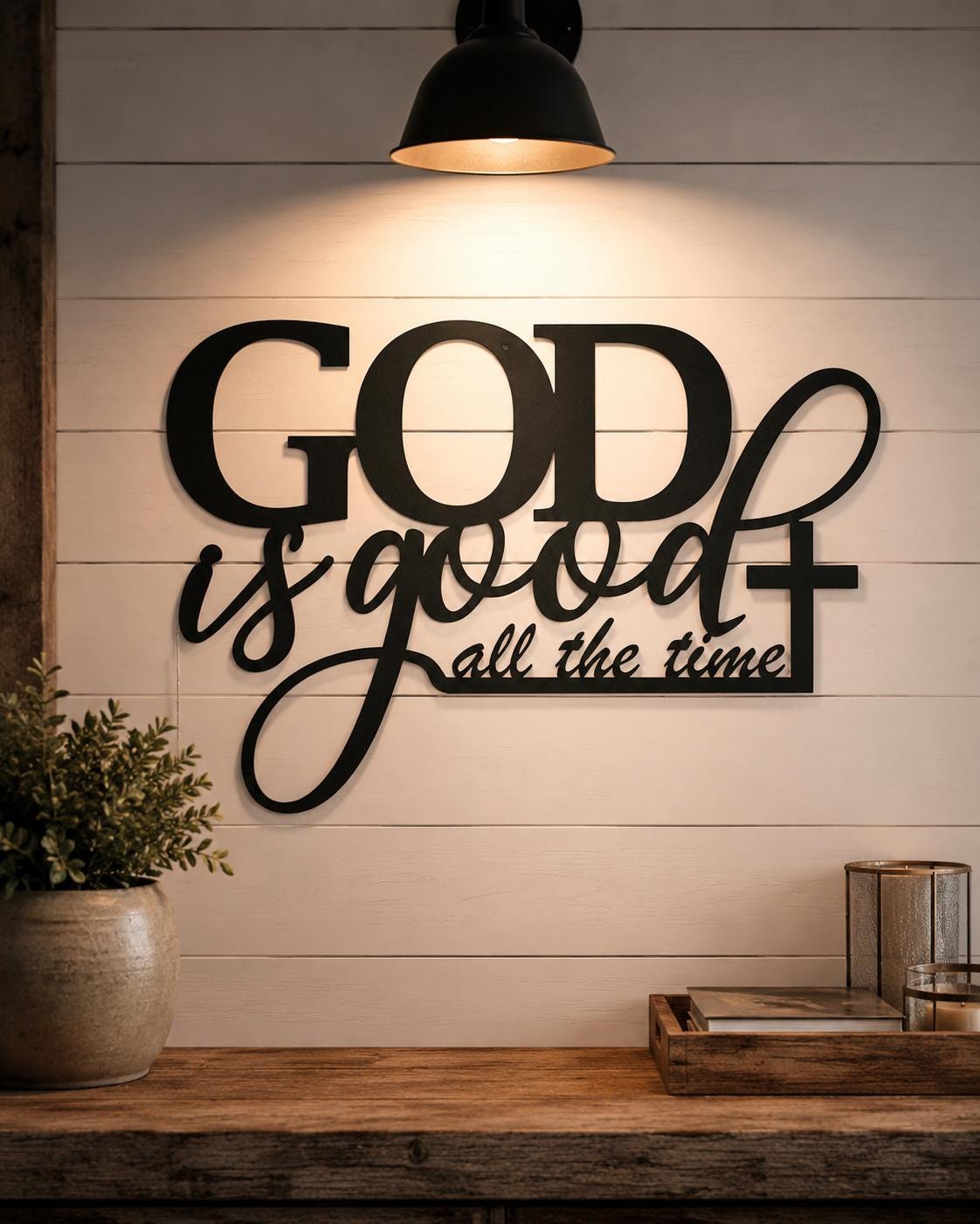 Decorative wall sign with 'GOD is good all the time' on a wooden wall.