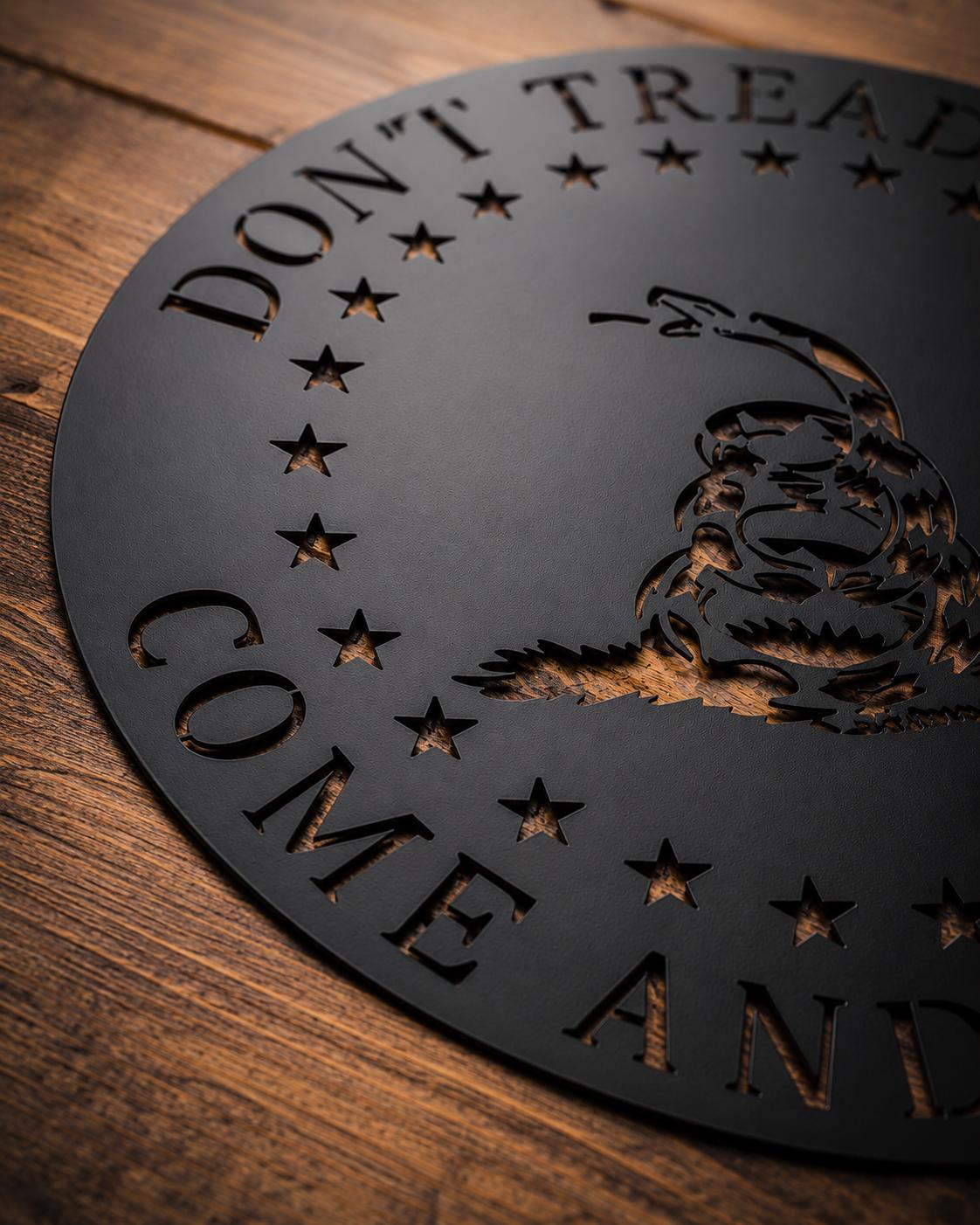 Black Don’t Tread On Me metal sign hanging in the powder-coating booth